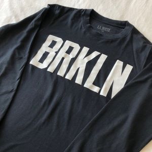 Long sleeve black shirt with “BRKLN” writing